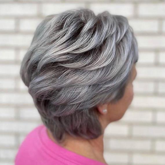 Back of woman’s head with short, gray, blow-dried hair.