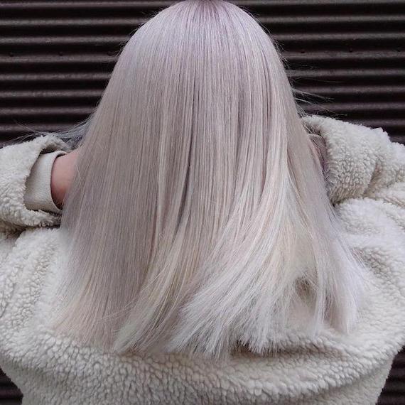 Back of woman’s head with mid-length, straight, icy gray hair.
