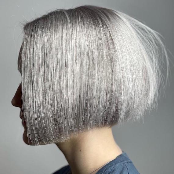 Side profile of woman with gray blunt bob haircut.