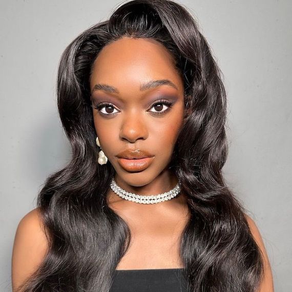 Model with black, glossy hair and Hollywood bombshell style blow-dry.