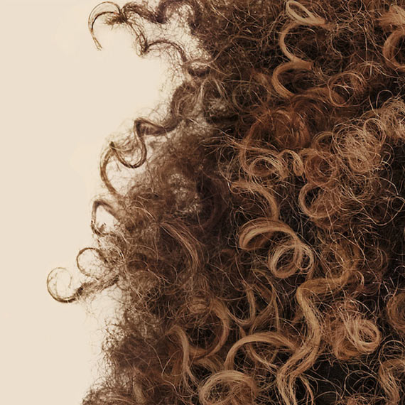 Close-up of brown, curly hair.