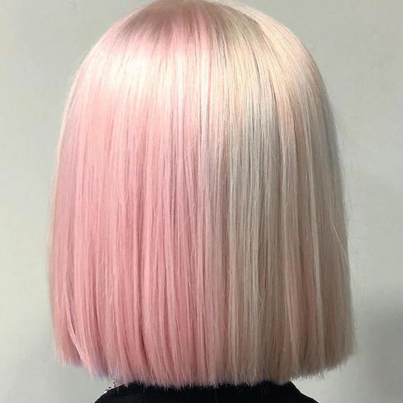 Back of woman’s head with half and half hair color in pastel pink and vanilla blonde, created using Wella Professionals.