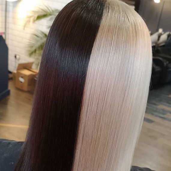 Back of woman’s head with half and half hair color in ice blonde and black, created using Wella Professionals.