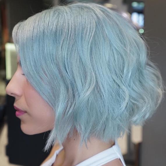 Side profile of woman with aqua blue bob hairstyle, created using Wella Professionals.