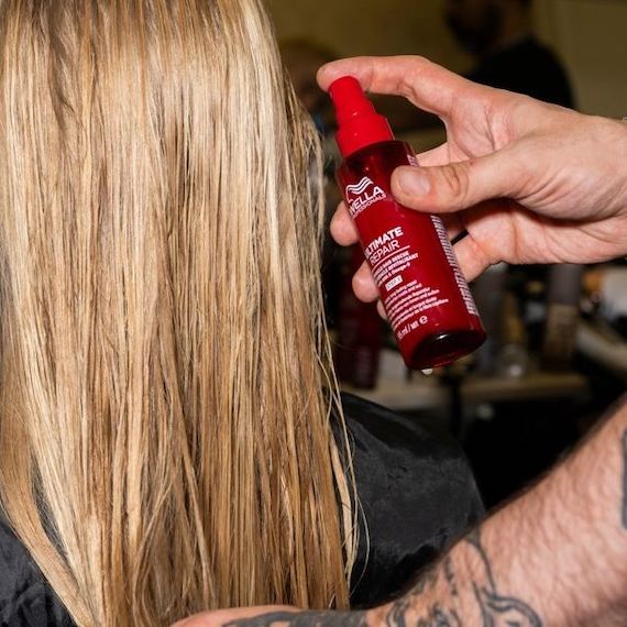 ULTIMATE REPAIR Miracle Hair Rescue is misted through a model’s hair backstage at Fashion Week.