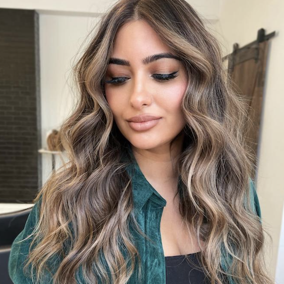 Headshot of a person with high contrast blonde balayage on brown hair