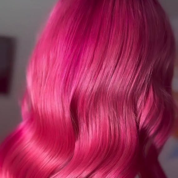Close-up of model’s neon pink hair.