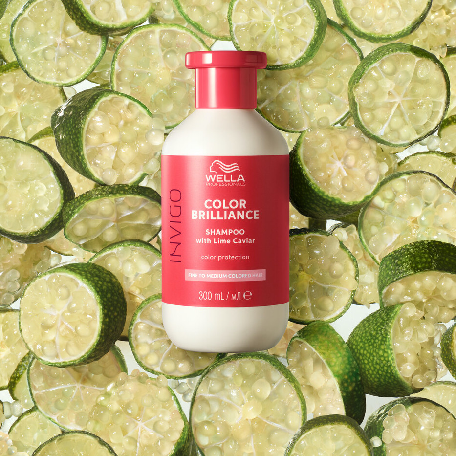 INVIGO Color Brilliance Color Protection Shampoo surrounded by slices of lime. 