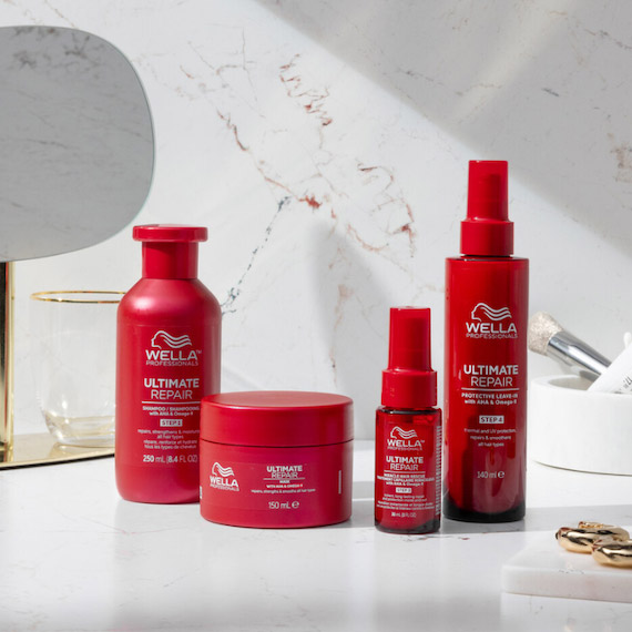 ULTIMATE REPAIR Shampoo, Mask, Miracle Hair Rescue and Protective Leave-In in a marble bathroom.