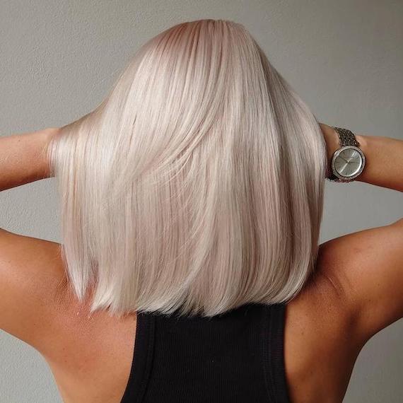 Back of woman’s head with icy blonde, long bob haircut, created using Wella Professionals.