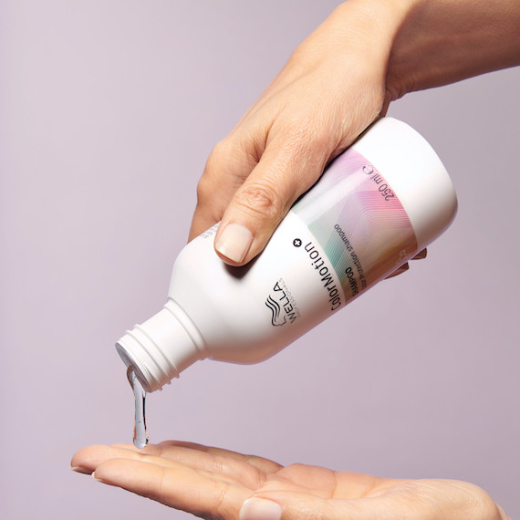 ColorMotion+ Color Protection Shampoo is poured into a model’s hand.