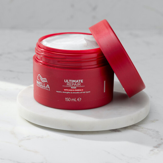 An open pot of ULTIMATE REPAIR Mask on a marble surface.