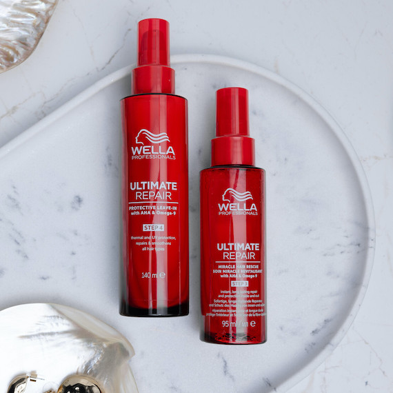 ULTIMATE REPAIR Protective Leave-In and Miracle Hair Rescue on a marble surface.
