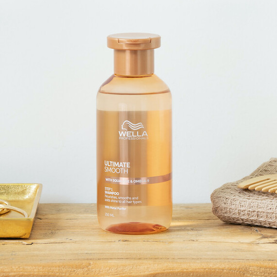 Bottle of ULTIMATE SMOOTH Shampoo on a wooden surface.