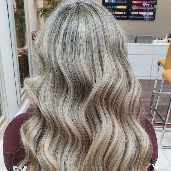 Back of model’s head showing long, silvery blonde, highlighted hair.