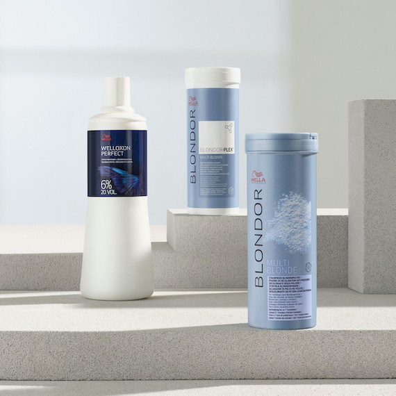 Wella Blondor products arranged on a grey stone surface. 