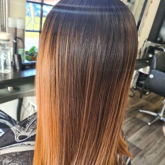 Client with brassy tones through brown hair.