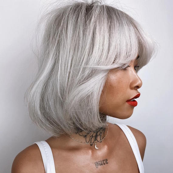 Side profile of woman with ice blonde bob hairstyle, created using Wella Professionals.