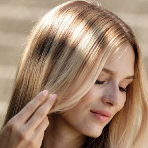 Side of a woman’s head with sun-kissed hair.