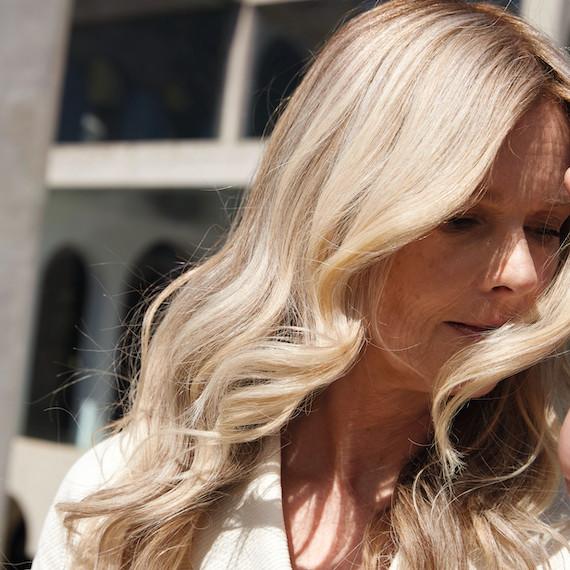 Close-up of wavy, creamy blonde hair created by Wella Professionals.