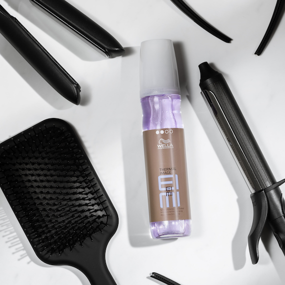 Wella’s EIMI Thermal Image spray is surrounded by hair tools.