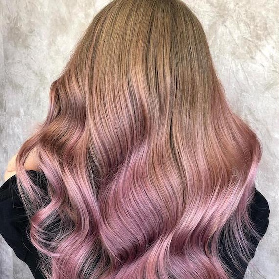 Back of woman’s head with long, blonde hair and blush pink ends, created using Wella Professionals.