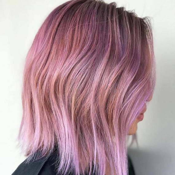 Side profile of woman with pink bob haircut, created using Wella Professionals.