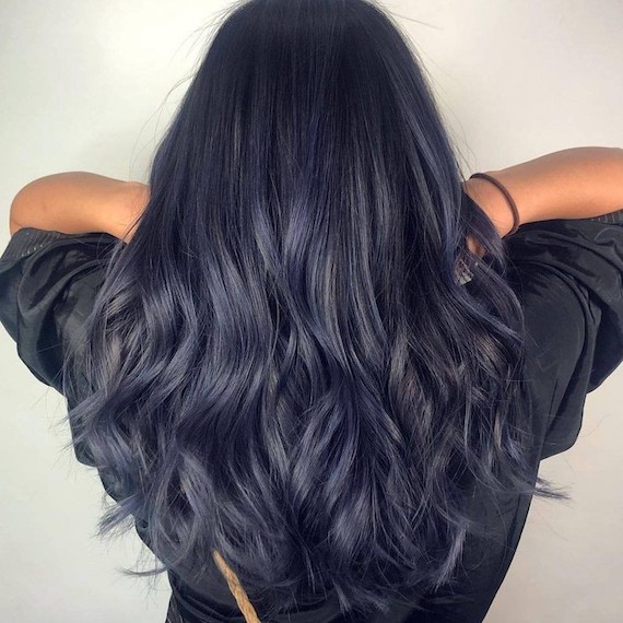 Back of model’s head with long, wavy, navy blue hair.