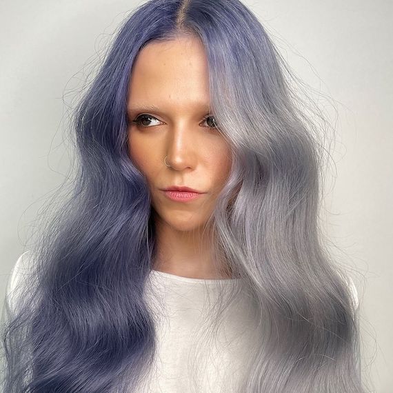 Model with gray-blue hair on one side and navy blue hair on the other.