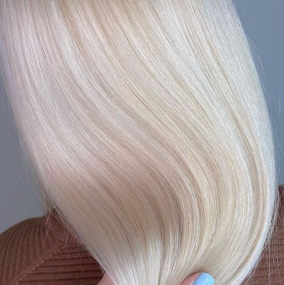 ‘After’ shot showing back of model’s head with long, straight, nordic blonde hair. 