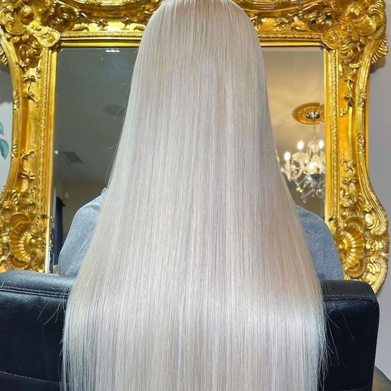 Back of model’s head with long, straight, nordic blonde hair.