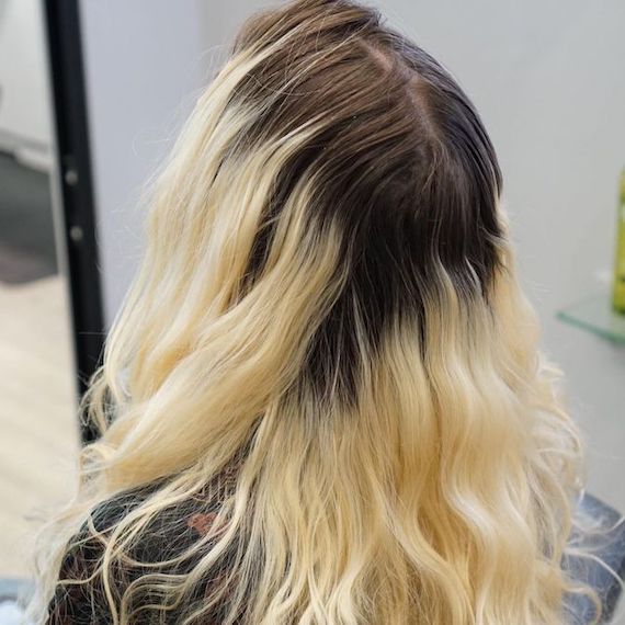 ‘Before’ shot showing model’s blonde hair with deep, dark roots.