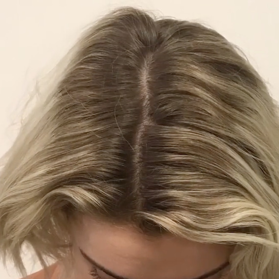 ‘Before’ shot showing close-up of model’s dark blonde hair and grown-out roots.