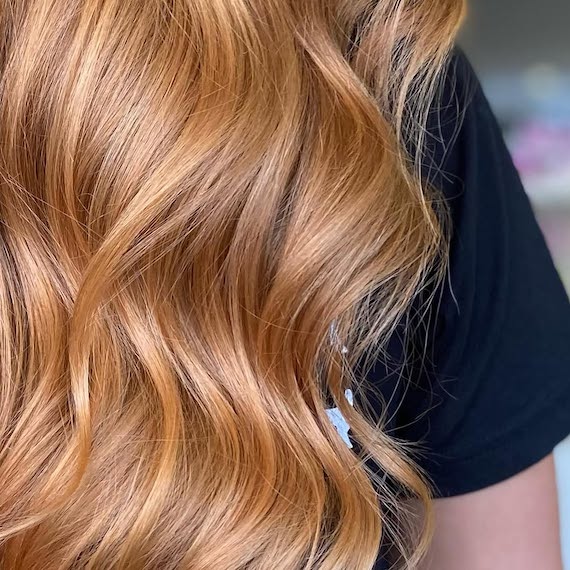 Close-up of model’s strawberry blonde hair.