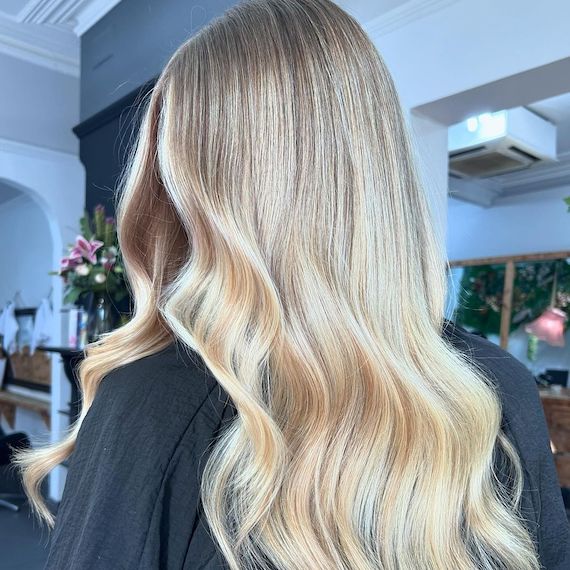 Model with long, loosely tousled, butter blonde hair.
