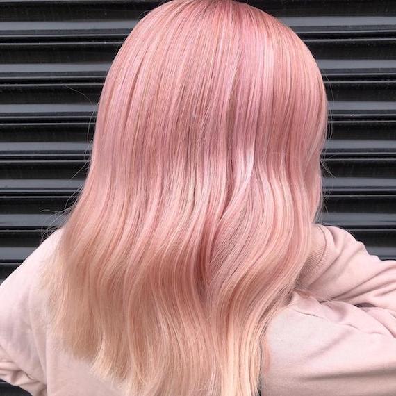 Back of woman’s head with mid-length, pink ombre hair, created using Wella Professionals.