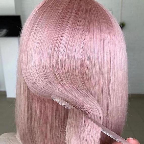 Back of woman’s head with short, baby pink hair, created using Wella Professionals.