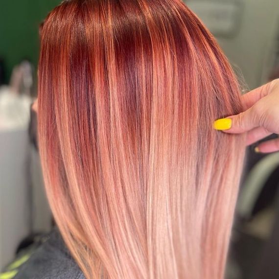 Side profile of model with peach blonde ombre hair.