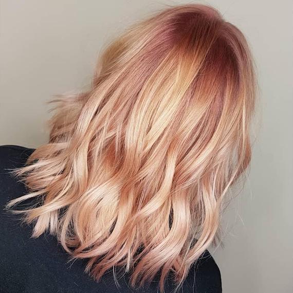 Back of model’s head with tousled, pale peach blonde hair.