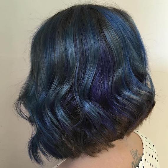 Side profile of woman with short bob and peacock hair color, created using Wella Professionals.