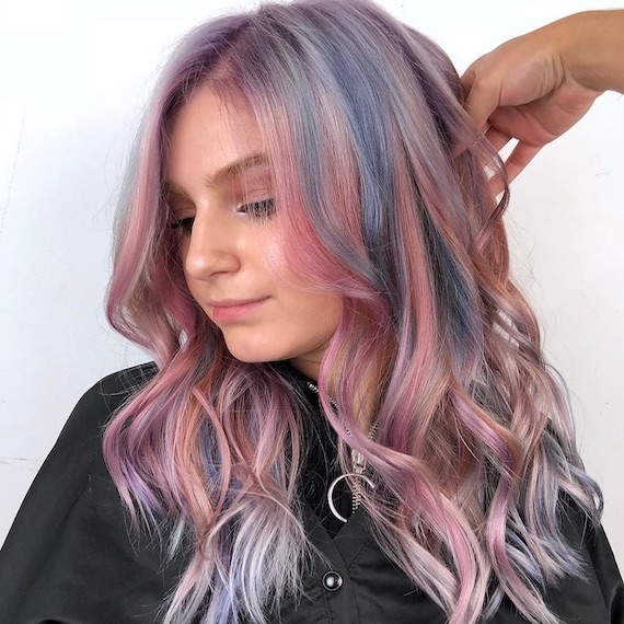 Side profile of model with pastel pink and blue highlights.