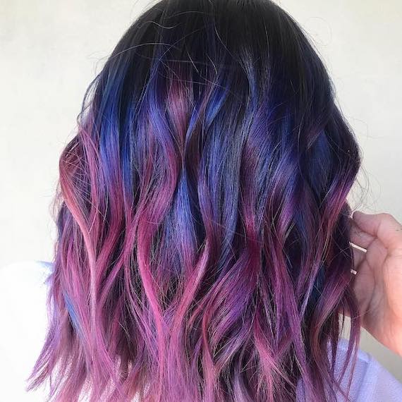 Back of model’s head with bright blue and pink ombre hair.