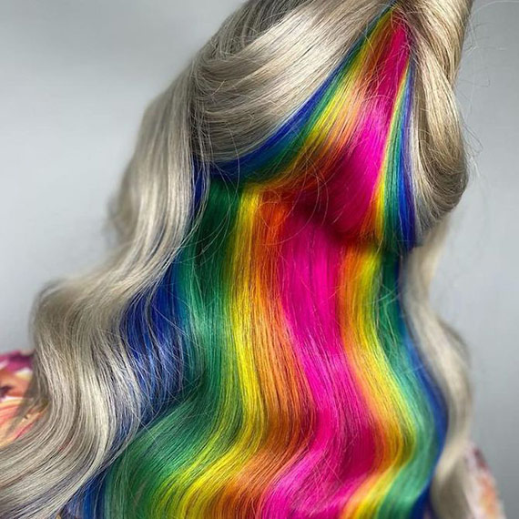 Model’s icy blonde hair features rainbow tones painted through the lower layers to represent the Pride flag.
