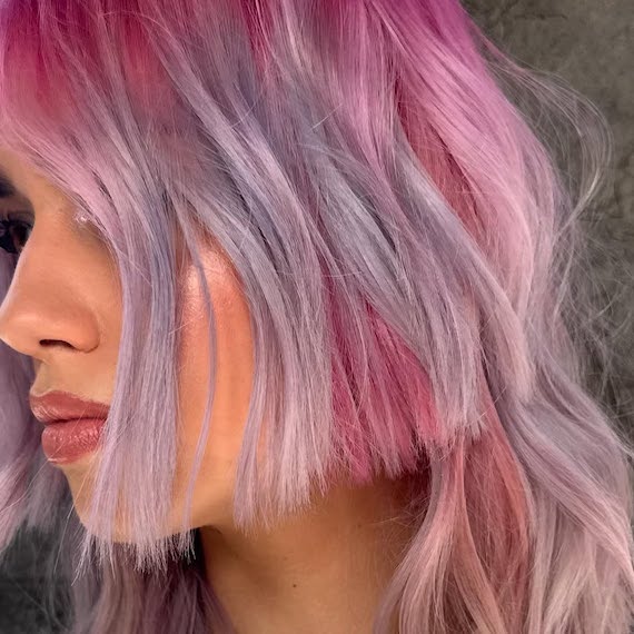 Close-up of model’s pink and purple ombre hair.