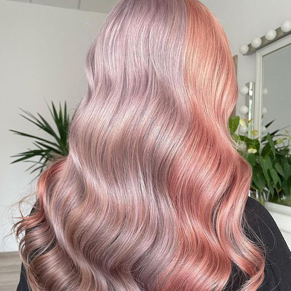 Back of model’s head with loosely curled pastel pink and purple hair in colour blocks.