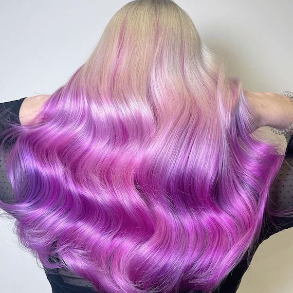 Back of model’s head with platinum blonde to magenta and purple ombre hair.