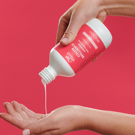 INVIGO Color Brilliance Shampoo is poured into hand. 