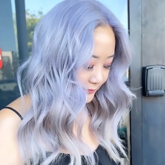 Side profile of model with pale lilac to silver blonde ombre hair.