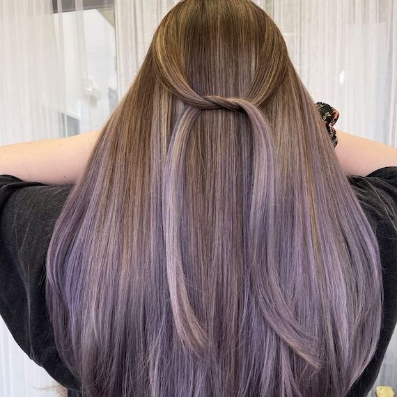 Back of model’s head with long, straight, dark blonde to lavender ombre hair.