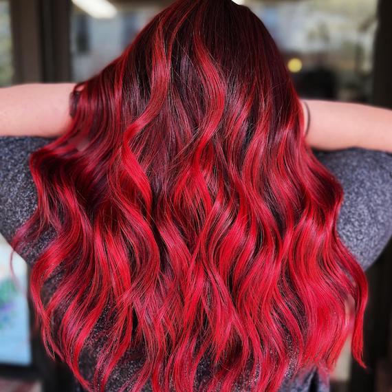 Back of head reveals a full head of red and black, wavy hair.